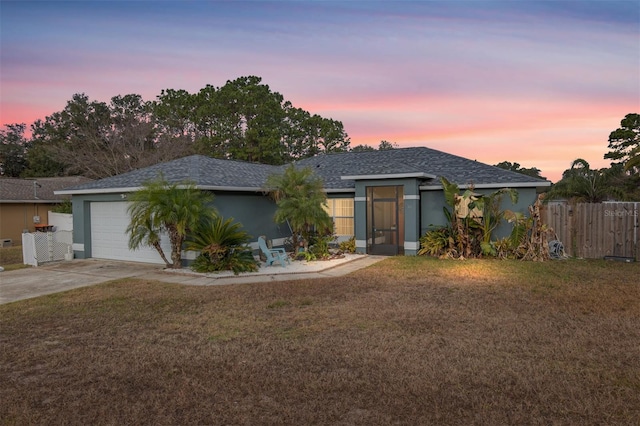 view of front facade featuring a garage and a lawn