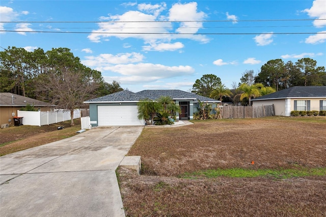 single story home featuring a garage and a front lawn