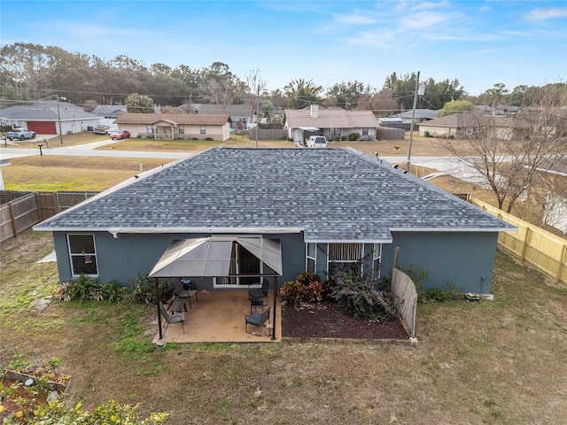 back of house with a patio area and a yard