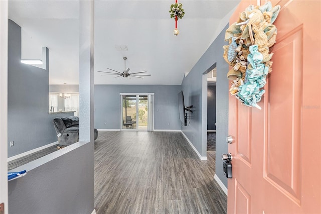 foyer entrance with ceiling fan and dark wood-type flooring