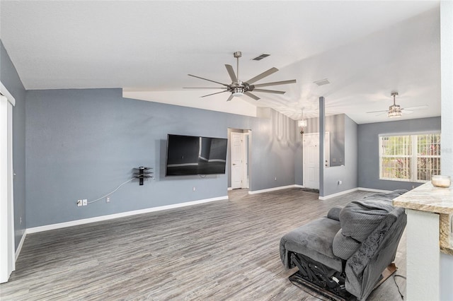 living room with ceiling fan, dark hardwood / wood-style flooring, and lofted ceiling