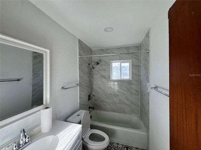 full bathroom featuring vanity, toilet, and tiled shower / bath