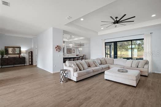 living room with hardwood / wood-style flooring and ceiling fan