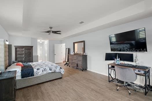 bedroom featuring ceiling fan and wood-type flooring