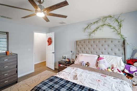 bedroom featuring wood-type flooring and ceiling fan