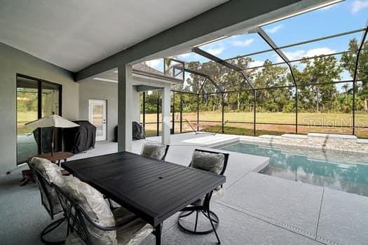 view of patio / terrace featuring a lanai