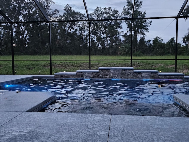 view of pool featuring pool water feature and glass enclosure