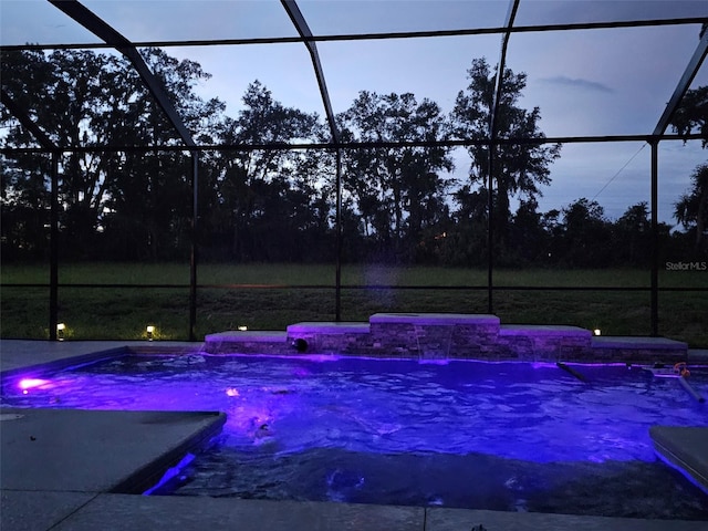 pool at dusk with glass enclosure