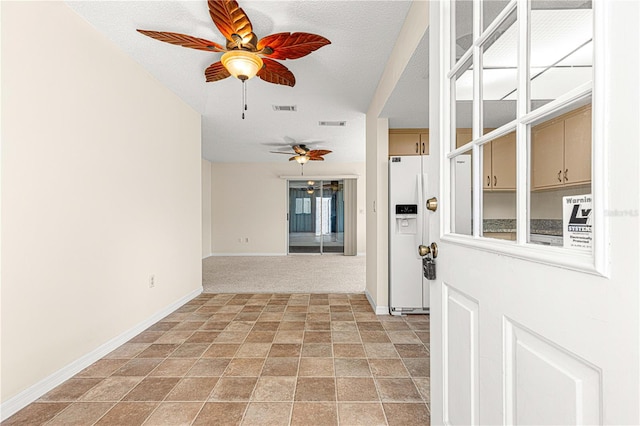 carpeted spare room with a textured ceiling