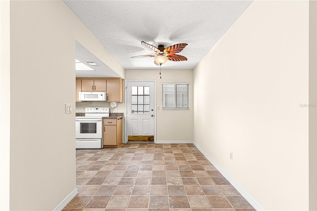 kitchen with a textured ceiling, ceiling fan, light brown cabinets, and white appliances