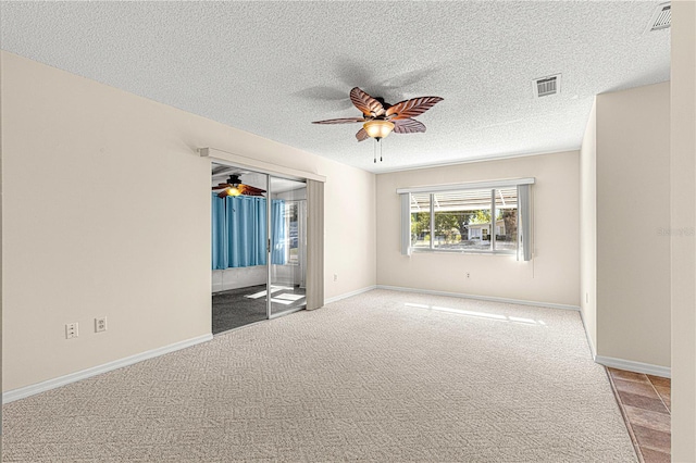 unfurnished bedroom featuring ceiling fan, a closet, carpet, and a textured ceiling