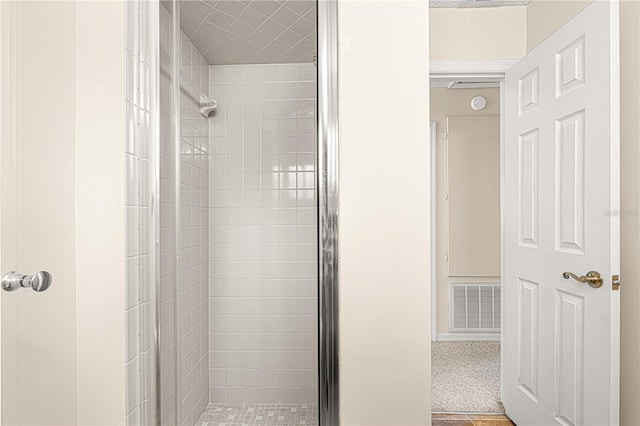 bathroom featuring a shower with shower door