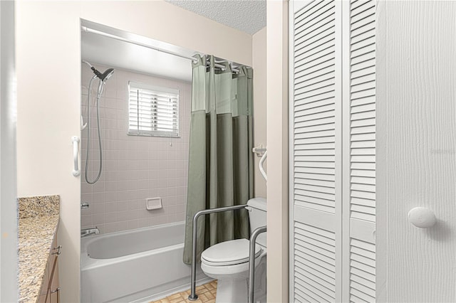 full bathroom with vanity, tile patterned floors, shower / bath combination with curtain, toilet, and a textured ceiling