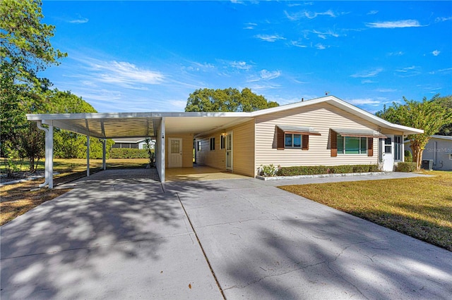 view of property exterior with a lawn and a carport