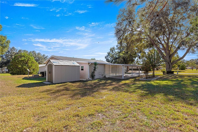 view of yard featuring a carport and a storage unit