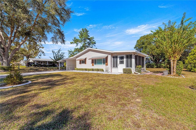 ranch-style house with a sunroom and a front lawn