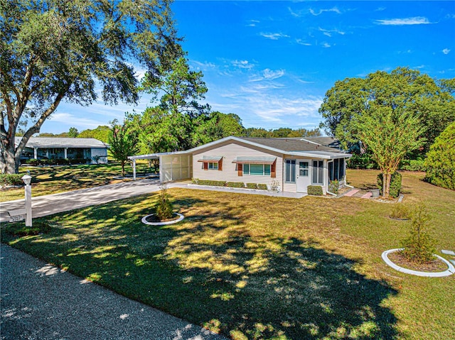 ranch-style house with a carport and a front lawn