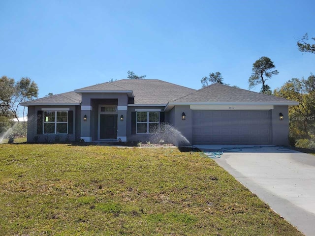 view of front of home featuring concrete driveway, a front yard, roof with shingles, stucco siding, and an attached garage