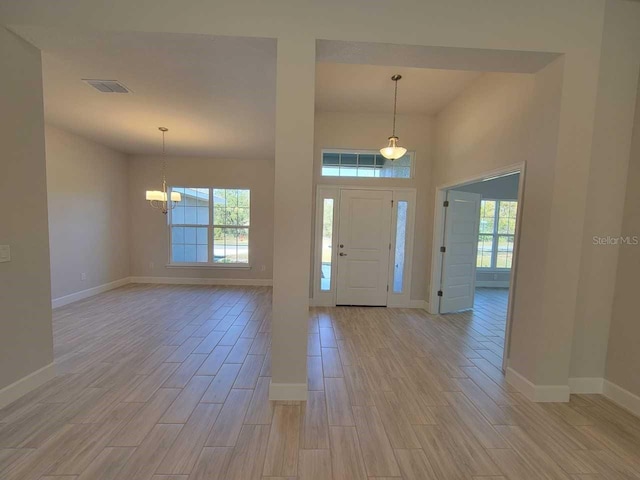 entryway with plenty of natural light, visible vents, and wood finish floors