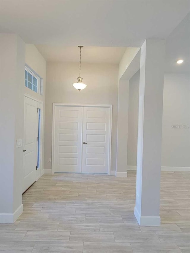 foyer featuring wood finish floors and baseboards