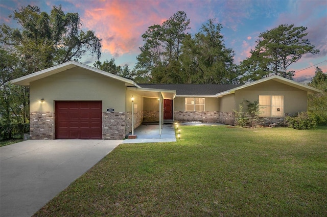 ranch-style home with a lawn and a garage