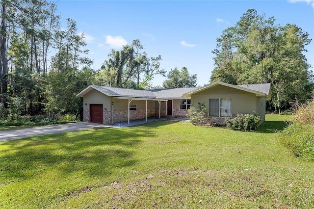 ranch-style home featuring a front lawn and a garage