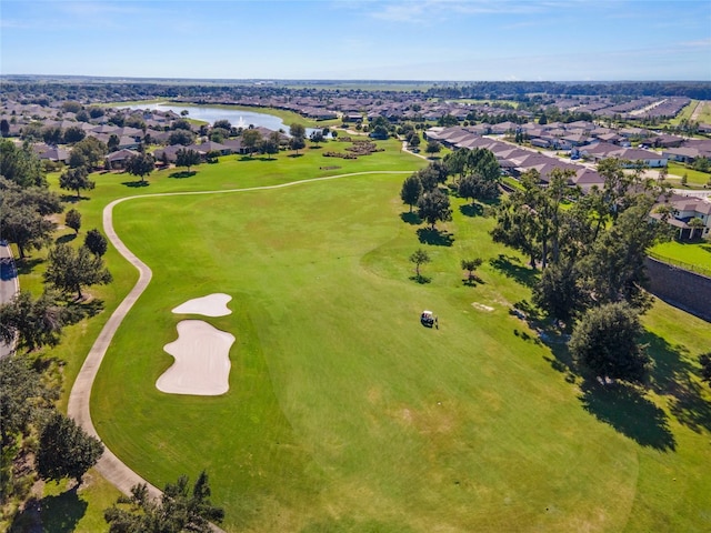 aerial view featuring a water view, view of golf course, and a residential view