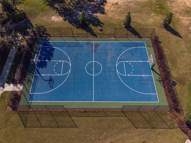 view of basketball court with community basketball court and a lawn