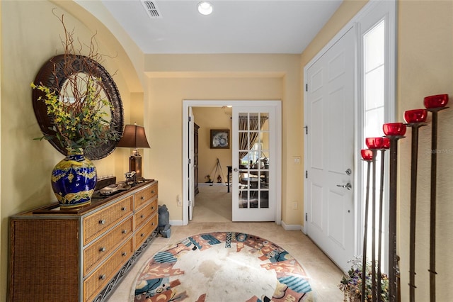 entrance foyer featuring baseboards, visible vents, and french doors