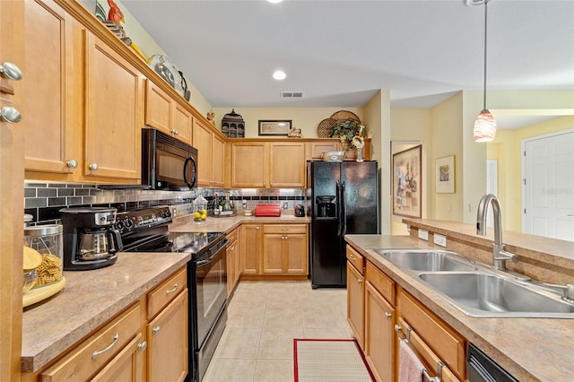 kitchen featuring a sink, visible vents, light countertops, black appliances, and decorative light fixtures