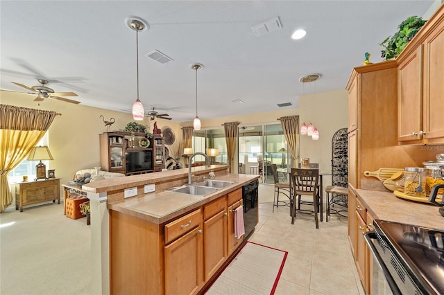 kitchen with open floor plan, hanging light fixtures, a sink, and visible vents