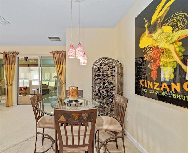 carpeted dining room with baseboards, visible vents, and tile patterned floors