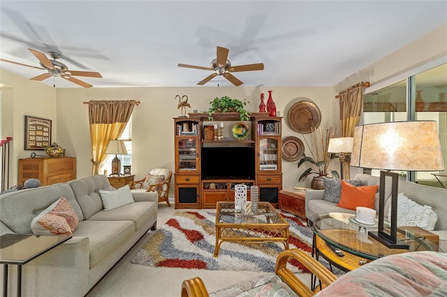 living area featuring a ceiling fan and carpet floors