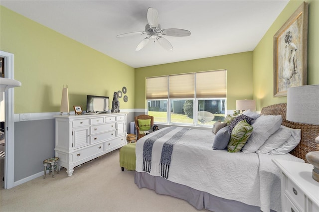 bedroom featuring light colored carpet, ceiling fan, and baseboards