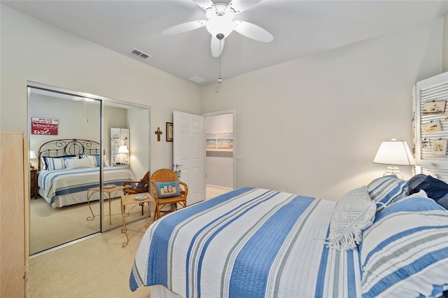 bedroom featuring carpet floors, a ceiling fan, visible vents, and a closet