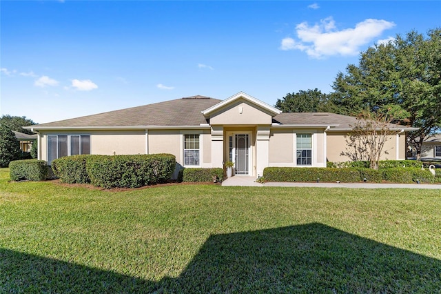 ranch-style home with a front yard and stucco siding