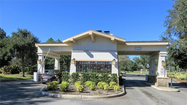 view of building exterior with aphalt driveway