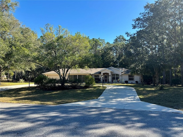 ranch-style home with a front lawn