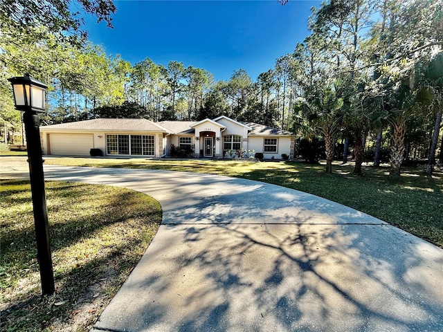 single story home featuring a front yard and a garage