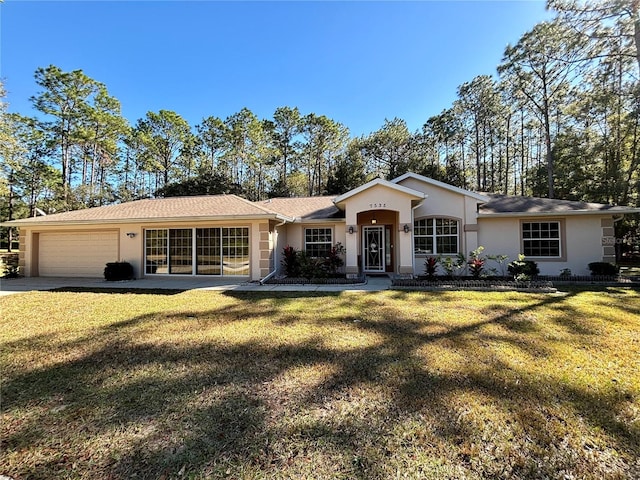 ranch-style home featuring a garage and a front lawn