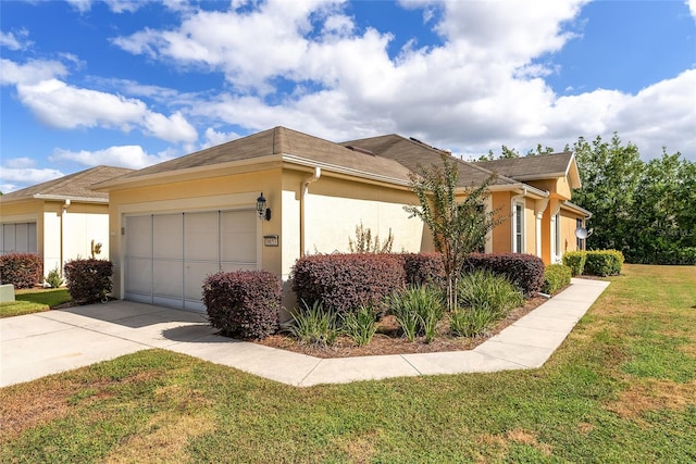 view of side of property with a garage and a yard