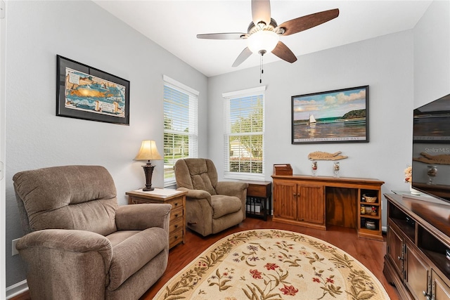 sitting room featuring dark hardwood / wood-style floors and ceiling fan