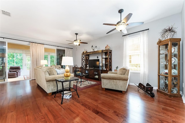 living room with hardwood / wood-style flooring, a wealth of natural light, and ceiling fan