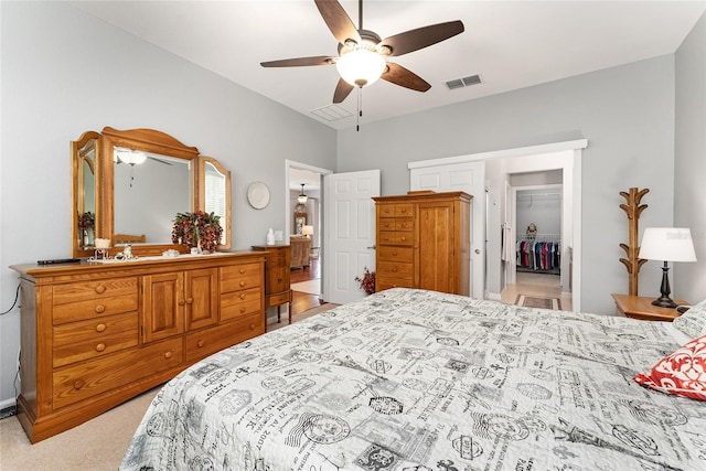 carpeted bedroom featuring a closet and ceiling fan