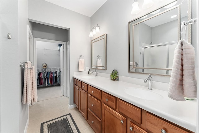 bathroom featuring tile patterned floors, vanity, and walk in shower