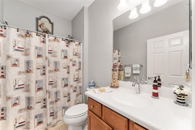 bathroom featuring tile patterned flooring, vanity, and toilet