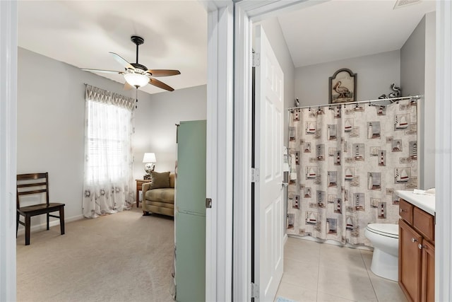 bathroom featuring vanity, tile patterned flooring, ceiling fan, toilet, and walk in shower