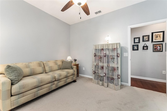 living room featuring ceiling fan, carpet floors, and lofted ceiling