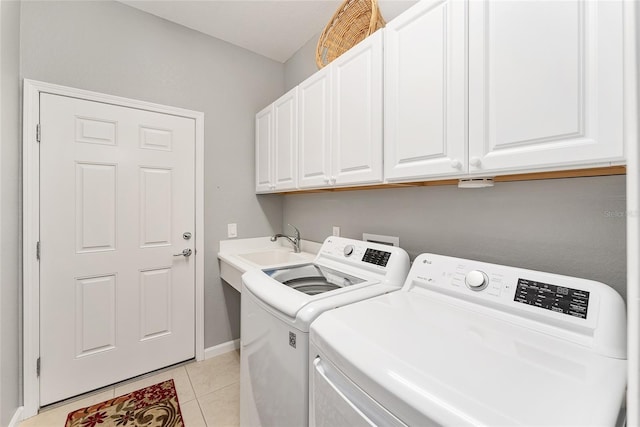 washroom featuring cabinets, independent washer and dryer, and light tile patterned floors