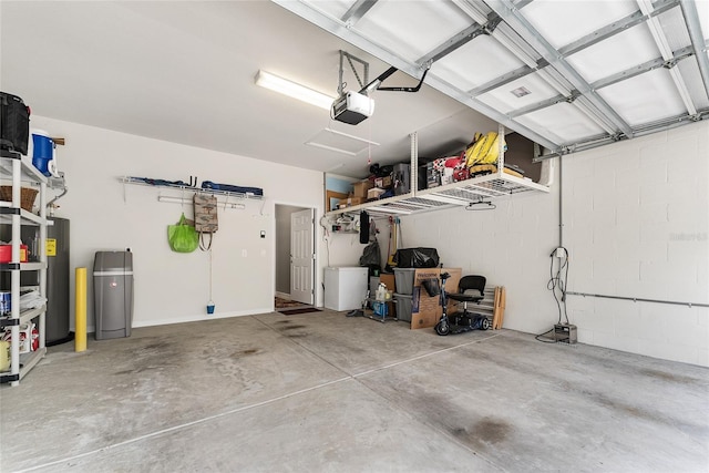 garage with a garage door opener and water heater